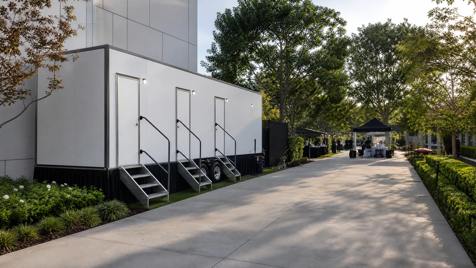 Portable restroom trailer deployed at a professionally planned outdoor event.